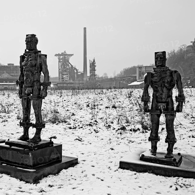 People made of iron, multi-part iron sculpture by Zbigniew Fraczkiewicz in front of the Henrichshütte in winter, Hattingen, Ruhr area, Germany, Europe