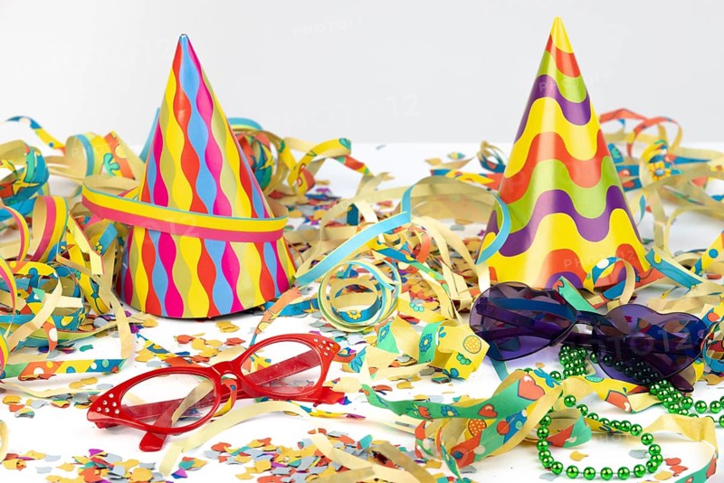 Colourful party hats with glasses and streamers as festive decoration, carnival
