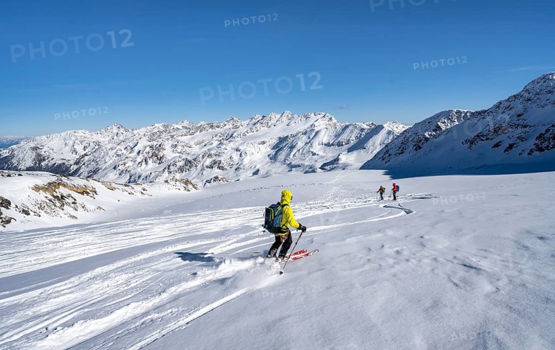 Ski tourers descending from the summit of Monte Cevedale on the Zufallferner, mountain panorama, snow-covered mountain landscape in winter, Ortler Alps, Vinschgau Valley, Italy, Europe
