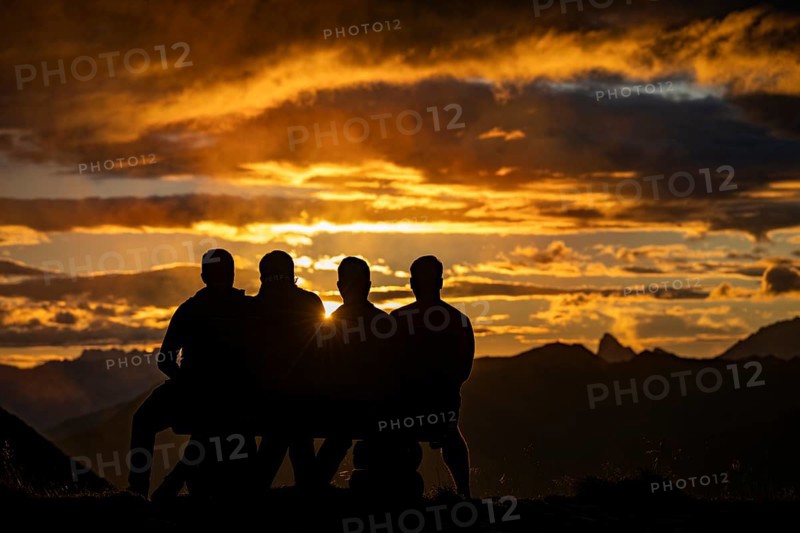People marvelling at Montafon mountains with dramatic cloudy sky at sunset, Tschagguns, Rätikon, Montafon, Vorarlberg, Austria, Europe