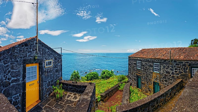 Rustic lava stone houses against a picturesque sea backdrop, fishing village, Sao Joao, Pico Island, Azores, Portugal, Europe