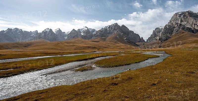 Kol Suu River between autumnal yellow meadows with mountain panorama of the Keltan Mountains, Sary Beles Mountains, Naryn Province, Kyrgyzstan, Asia