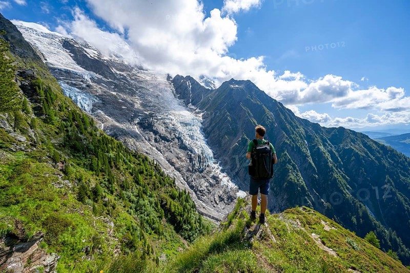 Mountaineer in front of impressive mountain landscape with glacier, view of glacier Glacier de Taconnaz, hike La Jonction, Chamonix, Haute-Savoie, France, Europe