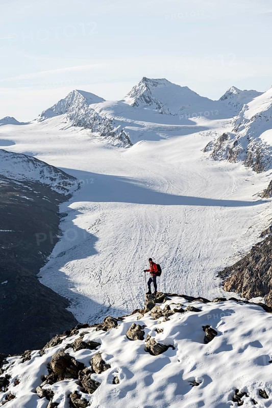 Mountaineer in front of mountain panorama and glacier, view of Gurgler Ferner with summit Hochwilde and Falschungsspitze, in the morning light, Ötztal Alps, Tyrol, Austria, Europe