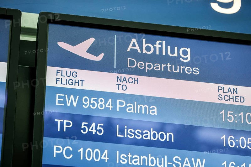 Düsseldorf, North Rhine-Westphalia, Germany - Düsseldorf Airport, departure to Majorca, display board shows departures to Palma and Lisbon, Easter holiday in times of the corona pandemic, in front of the departure to Spain and also in front of the return departure to Germany, air travellers must present a negative corona test