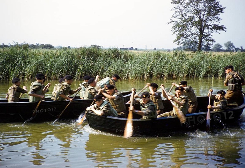 Students taking part in military exercises as army cadets, South of England, United Kingdom, late 1950s, paddling in boats on a river, Europe