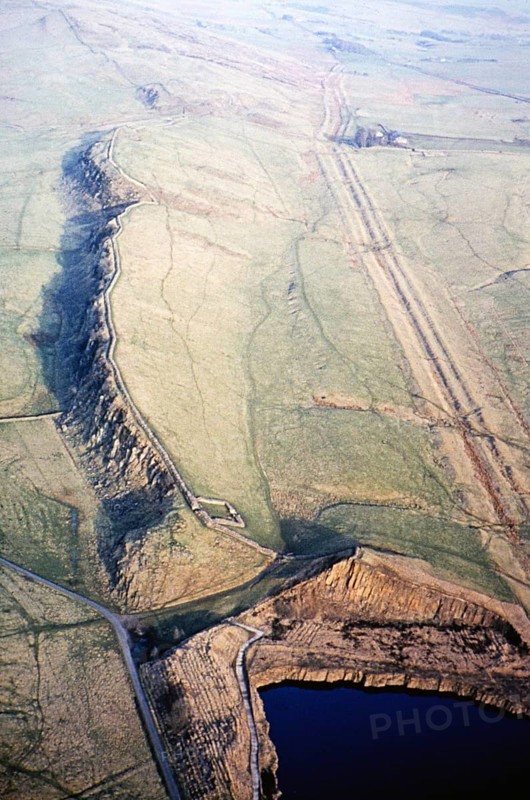 Series of oblique aerial photographs of sites associated with Hadrian's Wall, c. 1970s Whin Sill and Cawfields Quarry, Northumberland, England, UK from the west