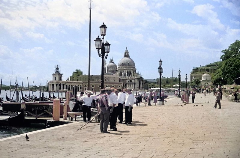 Gondoliers and gondolas, Riva degli Schiavoni, Basilica Santa Maria della Salute, Venice, Italy, Europe 1956 colourised image from Ektachrome slide, Europe