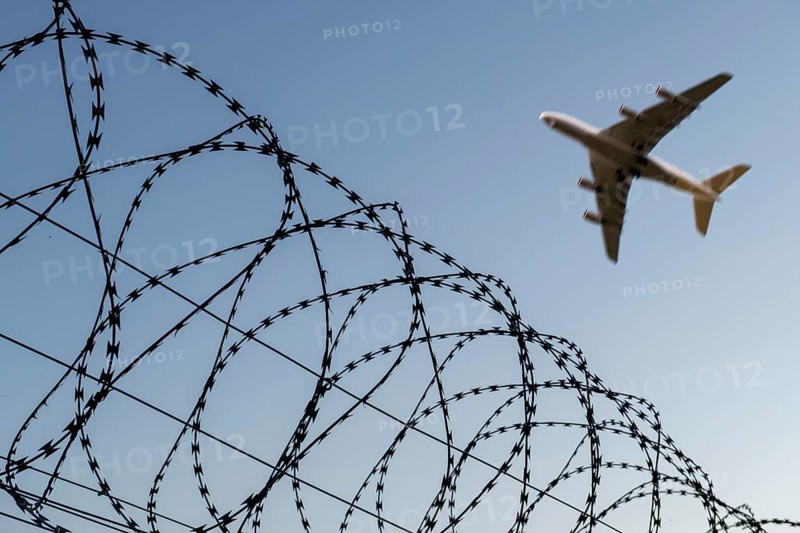 Symbolic image, deportation flights of illegal and delinquent migrants, passenger aircraft, airport, security fence, barbed wire, Germany, Europe