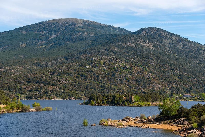 An idyllic lake in the middle of a wooded mountain landscape with small islands and calm waters, Burguillo reservoir, Alberche river, Ávila province, Avila, Sierra de Gredos, Spain, Europe