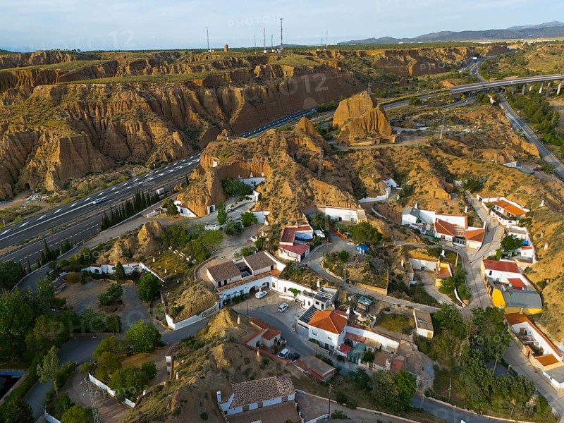 Aerial view of a housing estate in a rocky, hilly environment with cave houses and streets, aerial view, cave hotel, Cuevas Pedro Antonio de Alarcon, Guadix, Granada, Andalusia, Spain, Europe