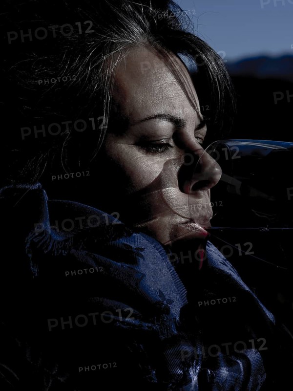 Headshot of a Happy Woman with Sunlight Drinking a Glass of Red Wine in Lugano, Ticino in Switzerland