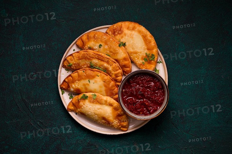 Fried mini pasties, with red sauce, top view, close-up, no people, selective focus