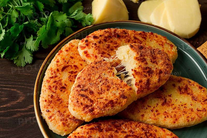 Chvishtari, corn flour tortillas with cheese, pastries, Georgian cuisine, Mchadi, homemade, top view, on a wooden table, no people