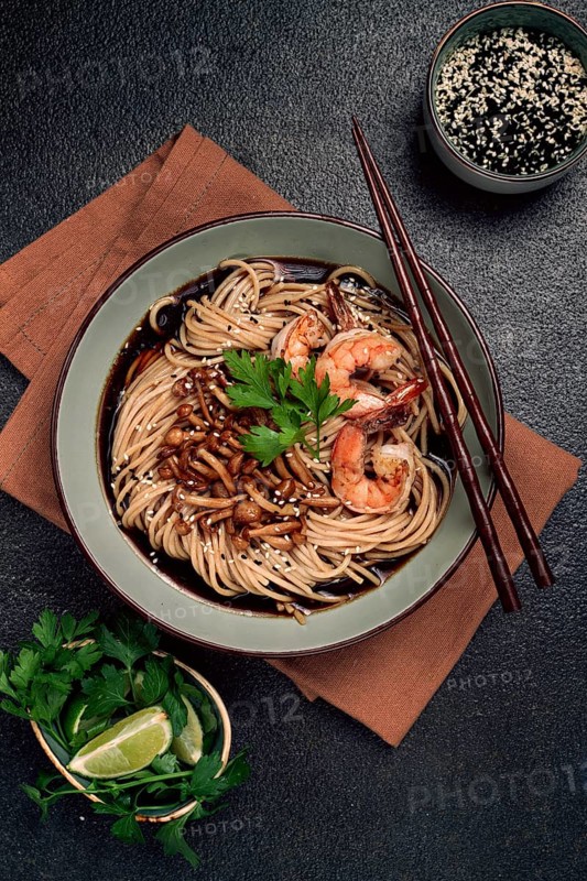 Soba, buckwheat noodles, with shimeji mushrooms and tiger shrimps, sesame, lime, parsley, homemade, no people