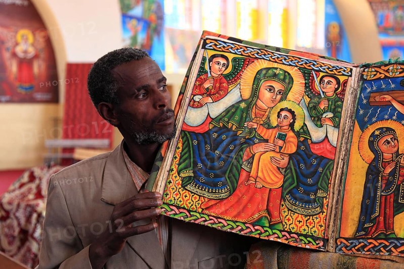 Tigray region, Axum, Aksum, St Mary's Cathedral, Maryam Tsion, inside, church servant shows old bible of the cathedral, Ethiopia, Africa