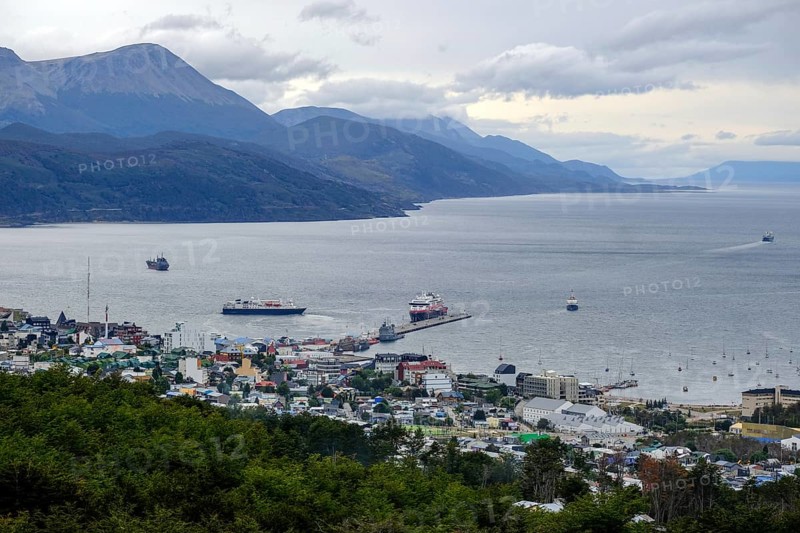 Ushuaia, Tierra del Fuego, Argentina, sunrise over the Beagle Channel, the Beagle Channel is a natural waterway at the southern tip of South America that connects the Atlantic Ocean with the Pacific Ocean. Ushuaia is the southernmost city in the world, the end of the world. Behind mountain range on the island of Navarino in Chile, Dientes de Navarino, South America
