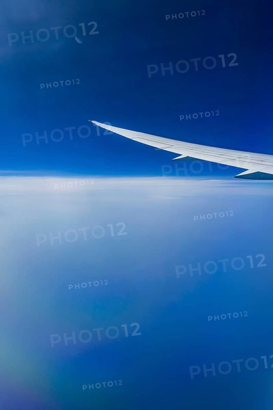 Blue sky, cloud structures over the Arabian Sea. View from the aircraft window during a flight from Phuket to Abu Dhabi with the airline Etihad. Wing of a Boeing 787 aircraft. Abu Dhabi, United Arab Emirates, UAE, Southwest Asia, Asia