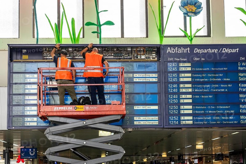 Technicians working on an electronic information board, display board for train connections at Düsseldorf Central Station, North Rhine-Westphalia, Germany, Europe