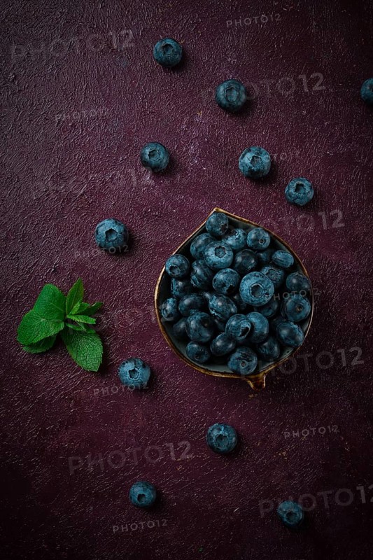 Fresh berries, Blueberries, on a maroon background, food concept, vertical, no people