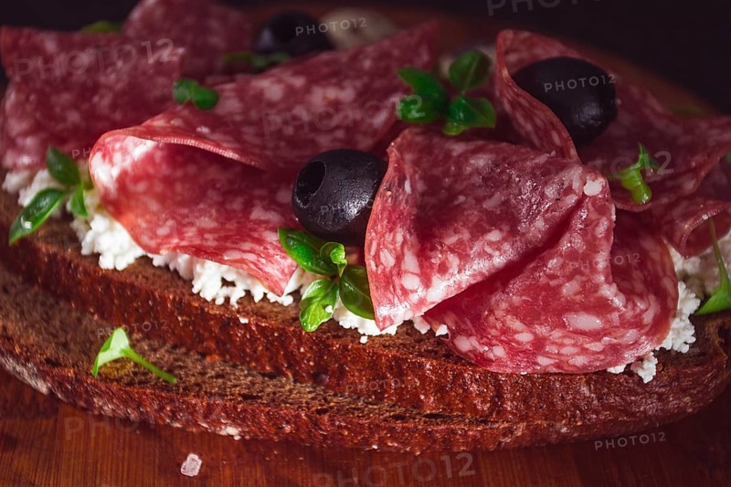 Sandwich, grain bread, with cream cheese and salami, black olives, micro-greens, top view, close-up, no people, Breakfast
