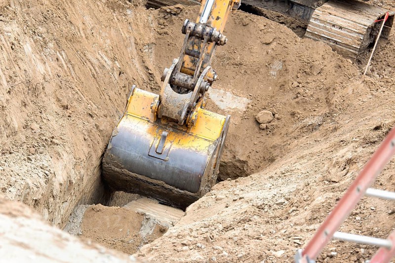Working excavator tractor digging A trench