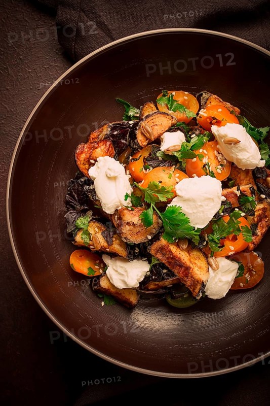 Warm Salad with crispy eggplant and tomatoes, cottage cheese, spices, herbs, sesame seeds, sunflower seeds, Georgian cuisine, no people