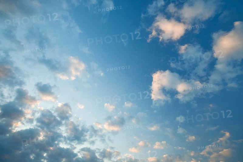 Fleecy clouds adorn the blue evening sky