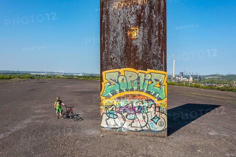Sculpture Bramme for the Ruhr area by Richard Serra, on the Brammentrail, mountain bike trail on the Schurenbach spoil tip, in Essen North Rhine-Westphalia, Germany, Europe