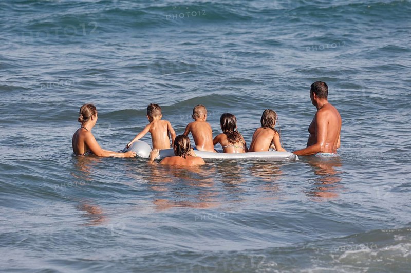 Families with children on an air mattress on the beach of Diano Marina, Italy, 14/08/2024, Diano Marina, Liguria, Italy, Europe