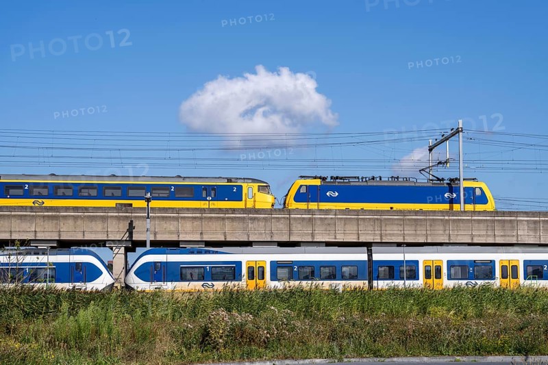 Trains of the Dutch railway, NS, Nederlandse Spoorwegen N.V., on a double-decker track, below local train Sprinter Light Train, above Intercity Direct train, near Hoofddorp, municipality of Haarlemmermeer, near Amsterdam