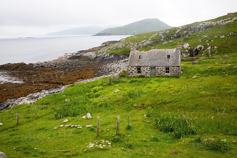 Deserted derelict croft cottage in coastal location on Vatersay Island, Barra, Outer Hebrides, Scotland, UK