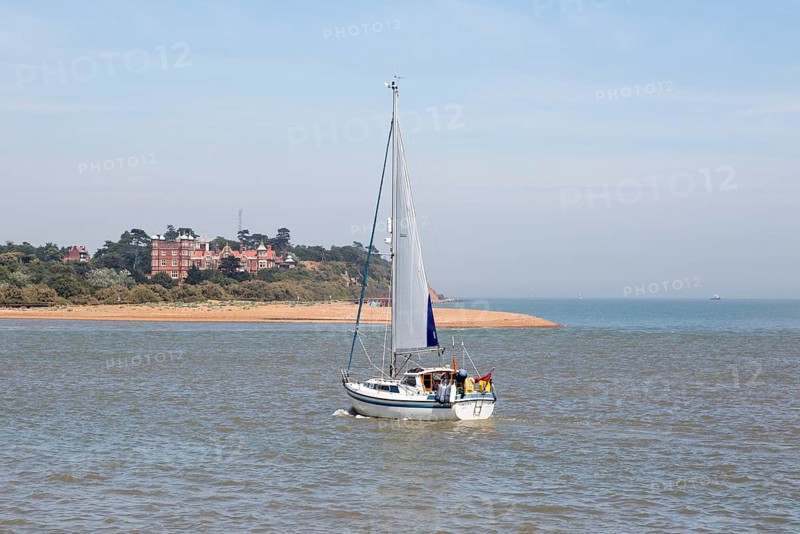 Sailing boat yacht in channel at mouth of River Deben estuary view Felixstowe Ferry to Bawdsey Manor, Suffolk, England, UK