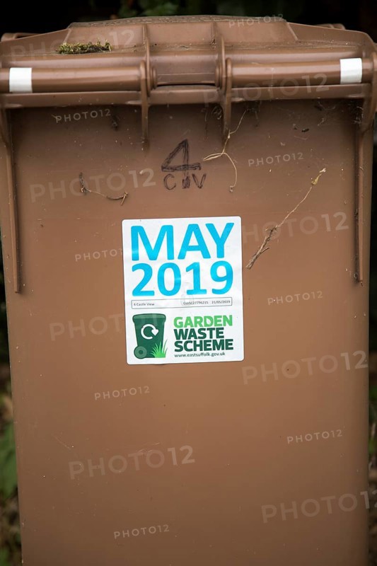 May 2019 date sticker on garden waste scheme brown compost collection bin, East Suffolk, England, UK