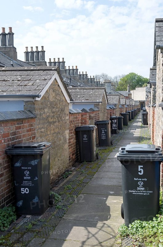Rubbish bins in back alley of nineteenth century model worker's housing, Railway Village Swindon, Wiltshire, England, UK