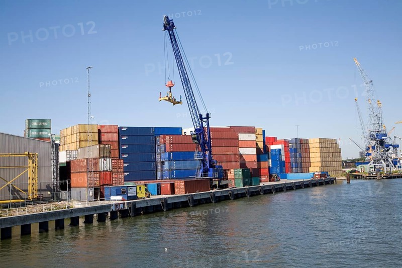Crane and colourful containers stacked on quayside, Port of Rotterdam, Netherlands