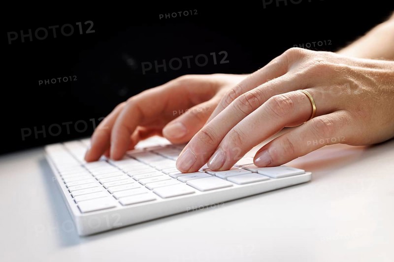 Hands typing on a keyboard in Berlin, 09/08/2024