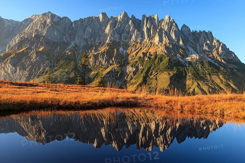 Rugged mountains reflected in a small mountain lake, autumn, evening light, Hochkönig, Mandlwand, Maria Alm, Tyrol, Austria, Europe