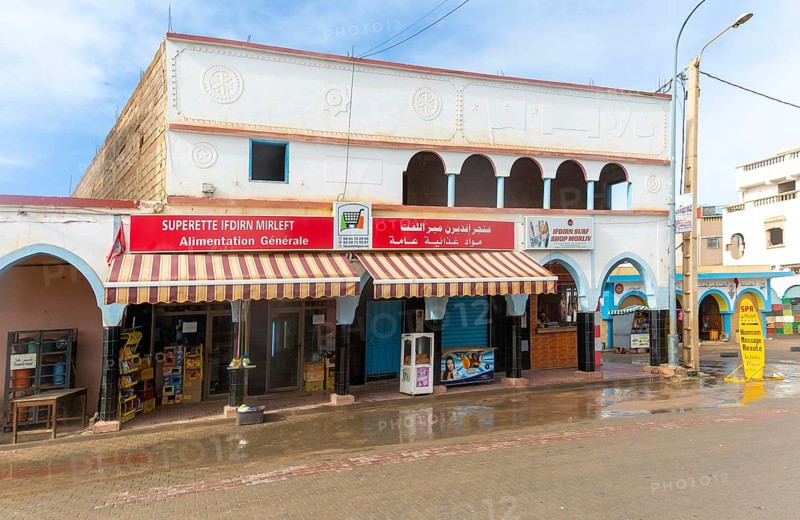 Historic buildings shops in arcaded shopping street in town centre, Mirleft, southern Morocco, North Africa
