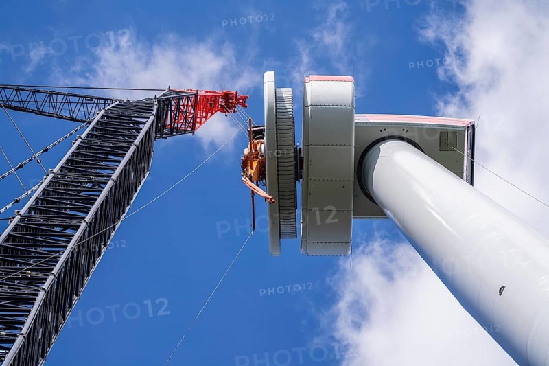 Erection of a wind turbine, wind energy plant, assembly of the ring generator, with a crawler lattice crane, wind farm near Hagen, North Rhine-Westphalia, Germany, Europe