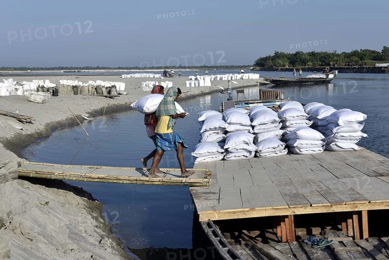 Public Works Department (PWD) of Assam labourer carrying sand bag to boat in Beki River to make sand bag wall to reduce soil erosion in Barpeta, Assam in India on Tuesday, November 13, 2018. The soil erosion of Beki river has become a major problem of flowing two districts Barpeta and Baksa of Assam