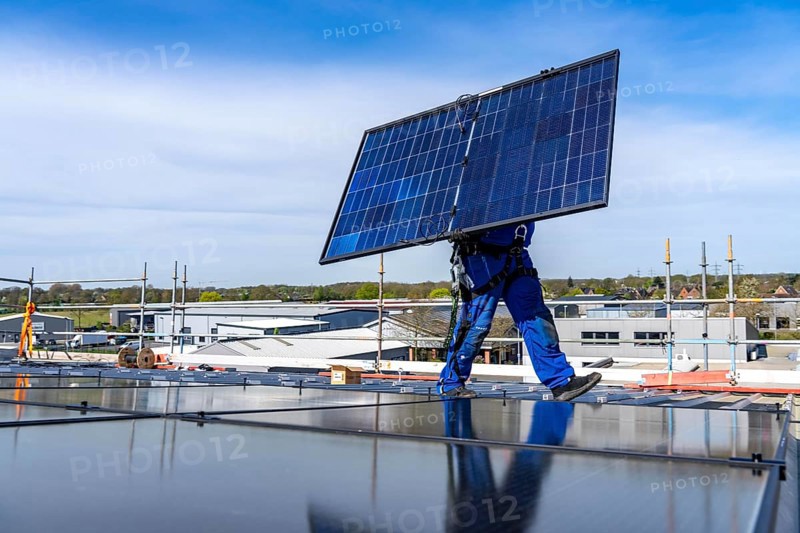 Installation of solar modules on the roof of a commercial enterprise, over 400 photovoltaic modules are installed on the roof, North Rhine-Westphalia, Germany, Europe