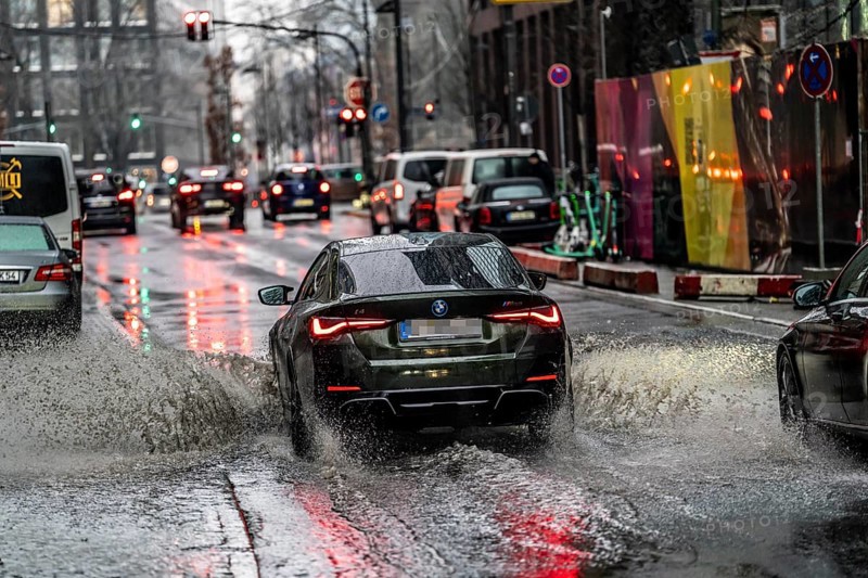 Winter, rainy weather, freezing rain, large puddle, puddle of water, in the city centre, Große Gallusstraße, vehicles driving through, spraying water fountains, Frankfurt am Main, Hesse, Germany, Europe