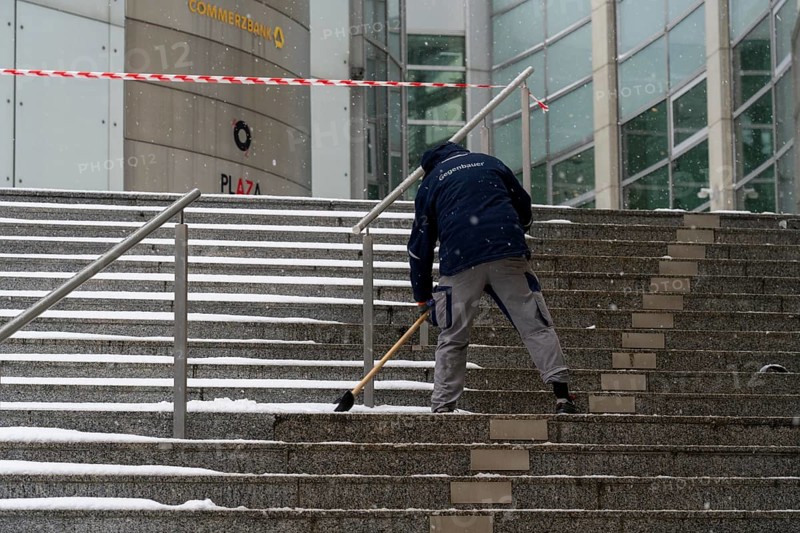 Onset of winter, winter service, clearing snow on the stairs of the Commerzbank building, Frankfurt, Hesse, Germany, Europe
