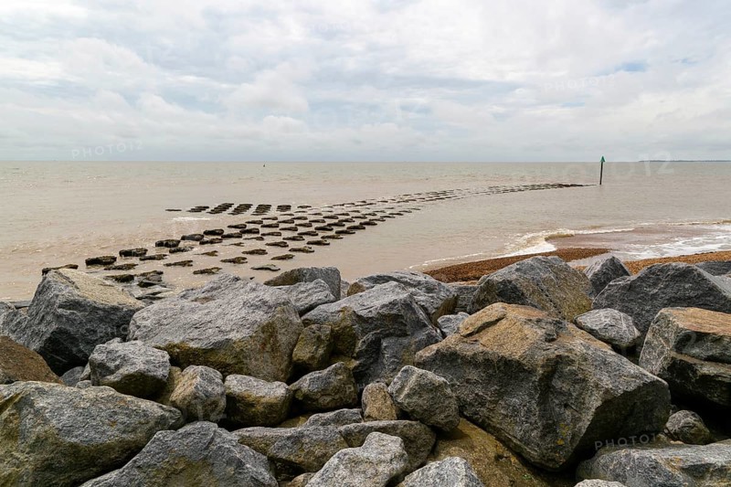 Fishtail reef coastal defences and rock armour at high tide, Cobbold's Point, Felixstowe, England, UK