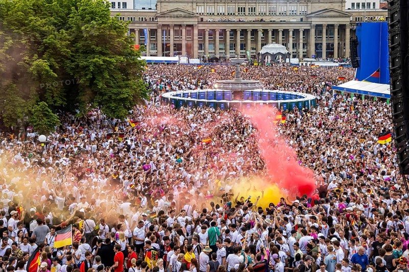 UEFA European Football Championship. Enthusiastic fans with pyrotechnics, public viewing in the host city of Stuttgart under the motto: the whole city is one stadium. 30, 000 football fans with German flags on the Königsbau on Schlossplatz in Stuttgart, Baden-Württemberg, Germany, Europe