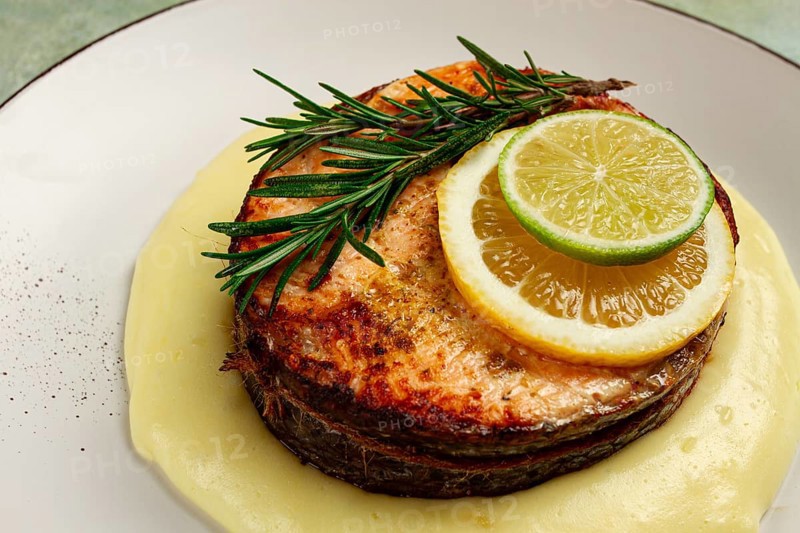 Salmon steak, fried, mashed potatoes, top view, rosemary, lemon and lime, homemade, one serving, no people