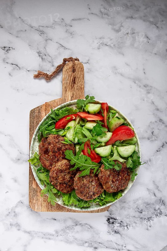 Fried cutlets, mixed minced meat, with vegetable salad, homemade, top view, no people