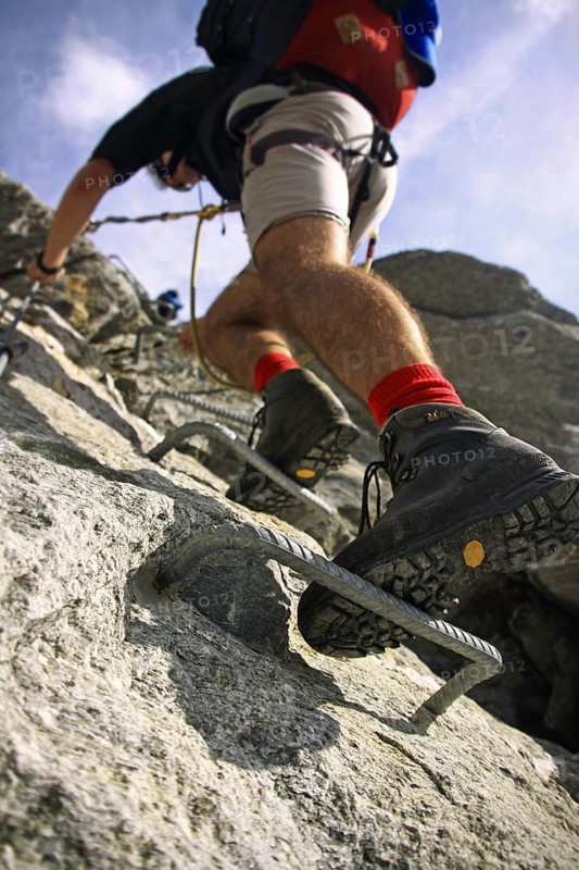 Close up of mountaineering boot of alpine climber climbing Via ferrata in the Zillertal, Tyrol, Austria, Europe
