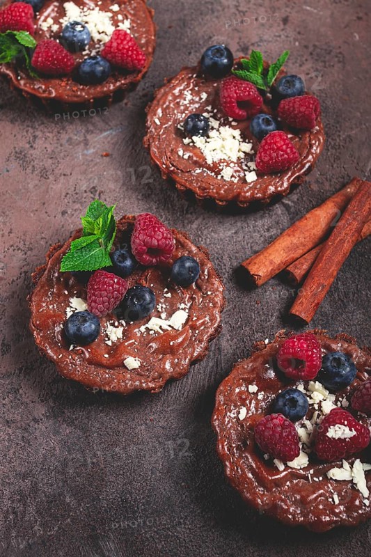 Chocolate tartlets, stuffed with cottage cheese and berries, breakfast, homemade, no people